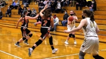 Ally Schultz fires in the three in first quarter action. Rudyard upset the Saints Friday night with a score of 51-47.