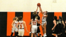Ally Schultz's shot is blocked by Laine Grenfell n Wednesday action in Rudyard.
