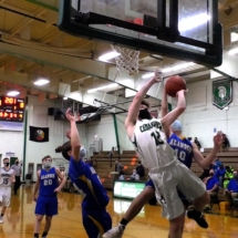 CASON SMITH IS FOULED HARD GOING TO THE BASKET IN THURSDAY EVENING ACTION AGAINST THE ALANSON VIKINGS.