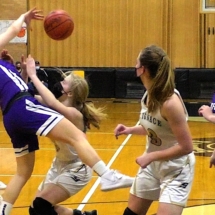 Emma Hart and Lizzie Storey collide going for a loose ball in basketball action St. Ignace Tuesday Night.