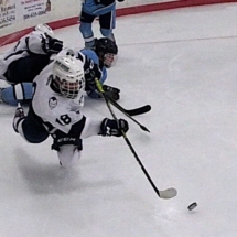 JACK SWAN LAYS OUT FOR THE PUCK..... IN FRIDAY NIGHT ACTION AGAINST PETOSKEY.