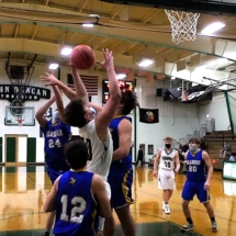 MIKEY PERKINS WINS THE REBOUND WAR WITH THREE PLAYERS FROM ALANSON THURSDAY EVENING. HE ALSO MADE THE PUT-BACK SHOT.